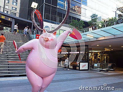 Cute pink pig sculpture with funny posture to celebrate year of the pig at World square building. Editorial Stock Photo